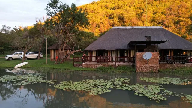 Lodge on the farm dam at sunset | Lobola Eco - Limpopo - Bela-Bela