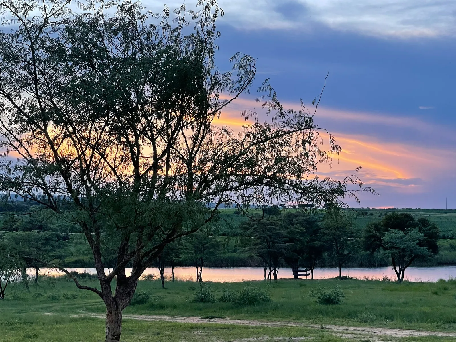 Sunset over the river from the farm lawn at Groendraai River Cottages | Groendraai River Cottages - Limpopo - Vaalwater