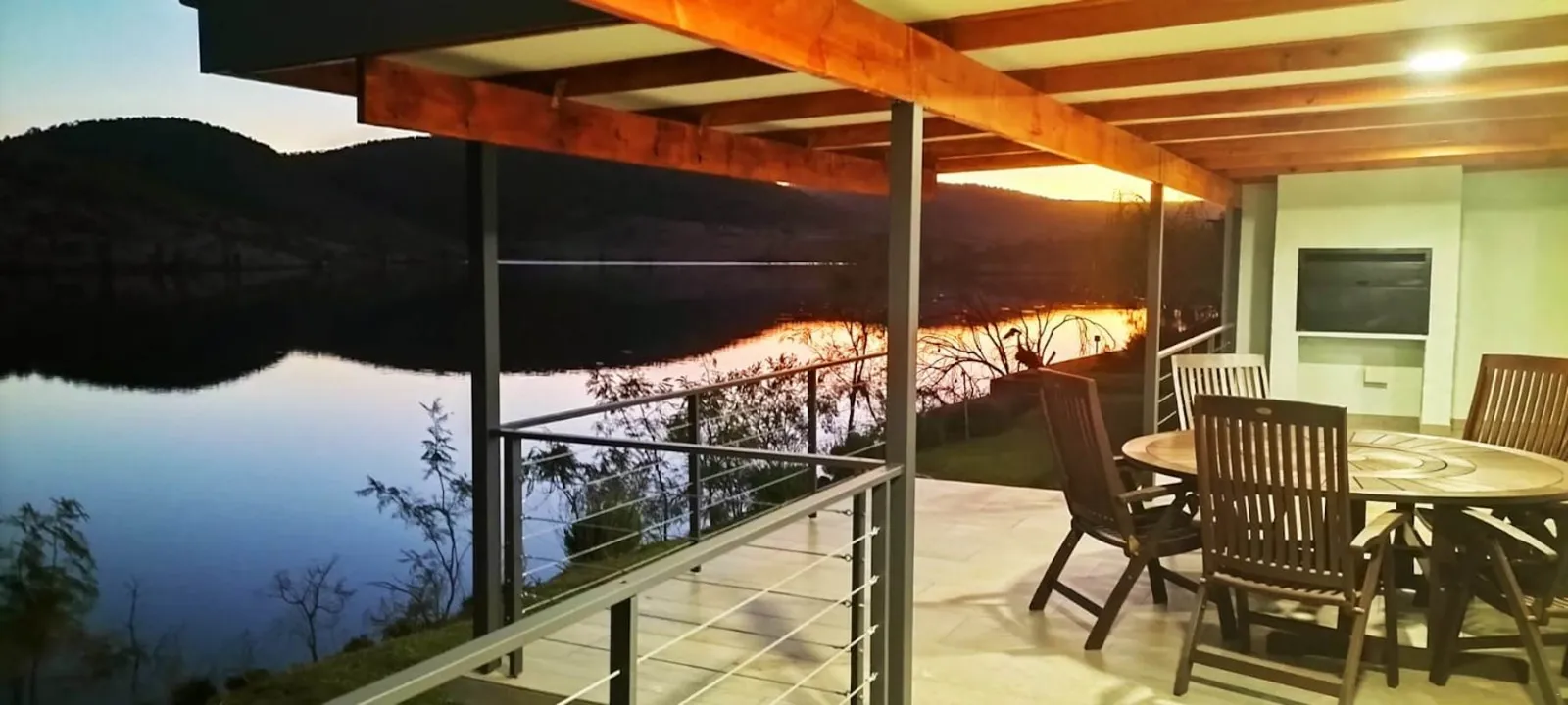 Deck overlooking the dam at dusk | Fish Eagle Bay Boat Club - Limpopo - Warmbad - Warmbad Dam
