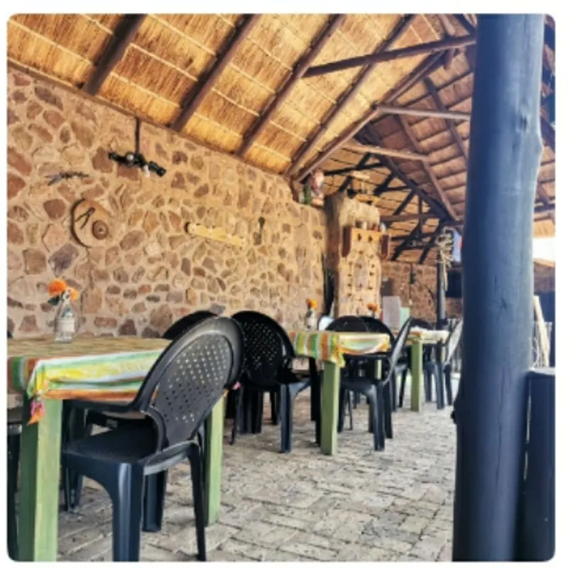 Thatched dining lapa with stone wall | Kwemvubu Lodge - Mpumalanga - Groblersdal - Loskop Dam