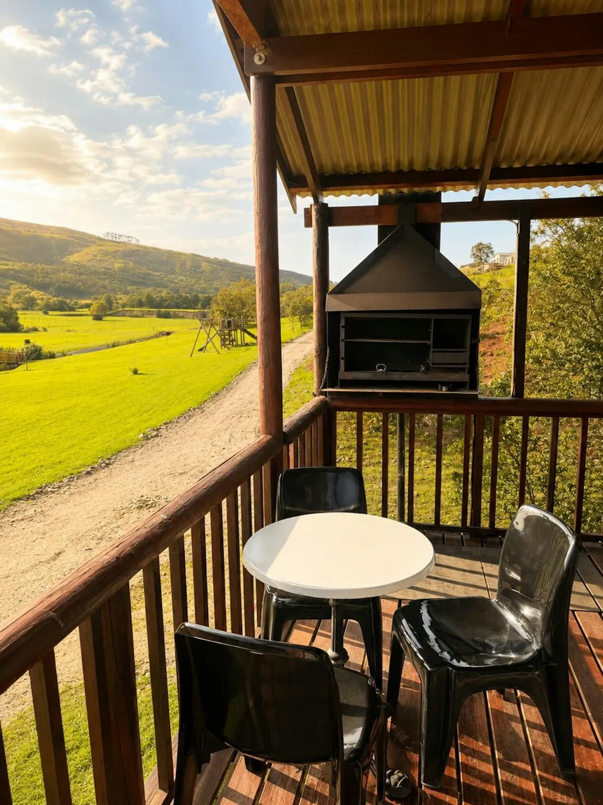Deck table and chairs by a braai at Takbok, FleckVieh | Fleckvieh Guest Farm - Takbok - Western Cape - Swellendam