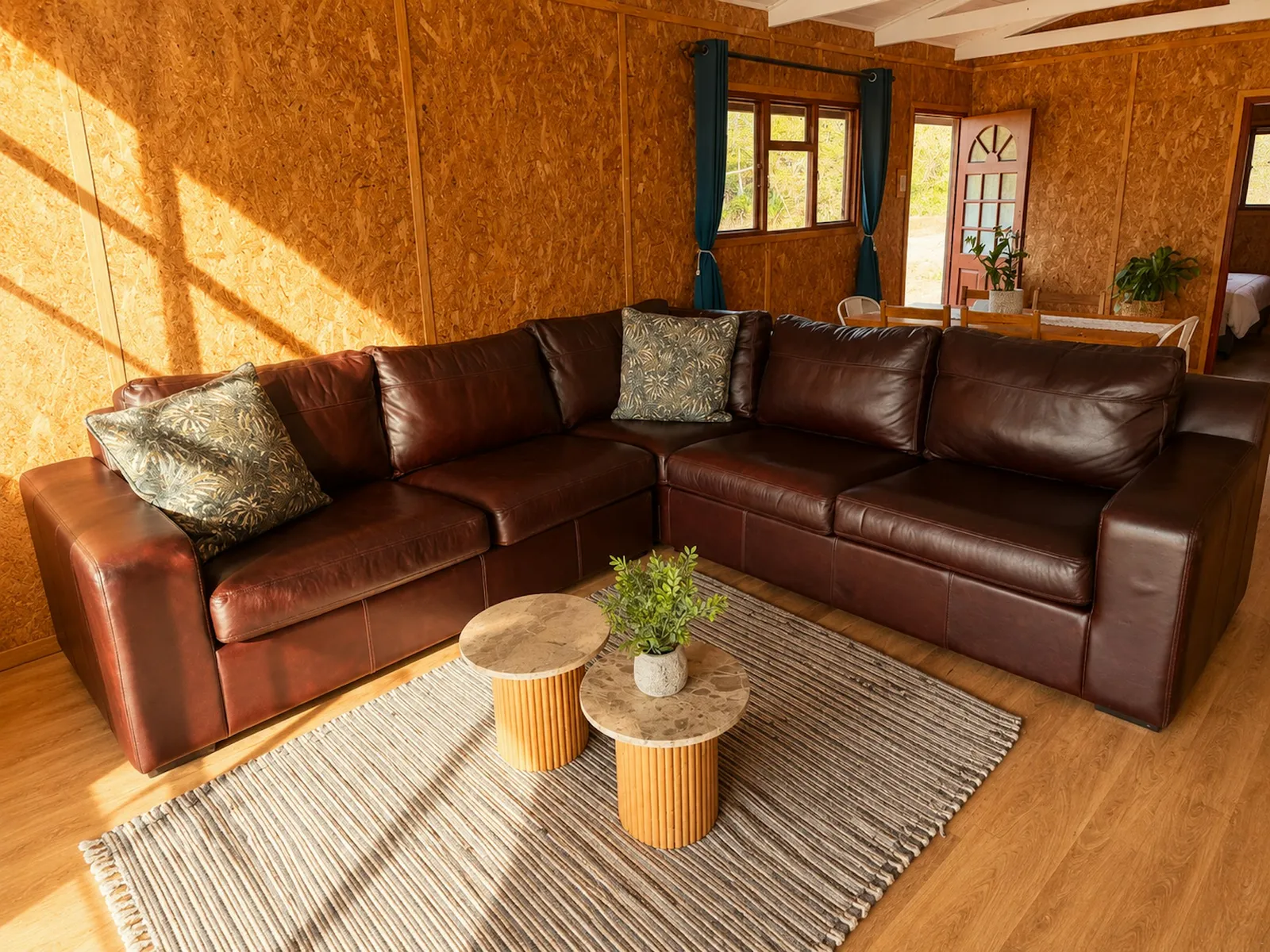 Brown leather corner sofa and two coffee tables at Eland, FleckVieh | Fleckvieh Guest Farm - Eland - Western Cape - Swellendam