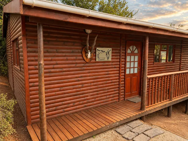 Log cabin porch with an antelope mount at Eland, FleckVieh | Fleckvieh Guest Farm - Eland - Western Cape - Swellendam