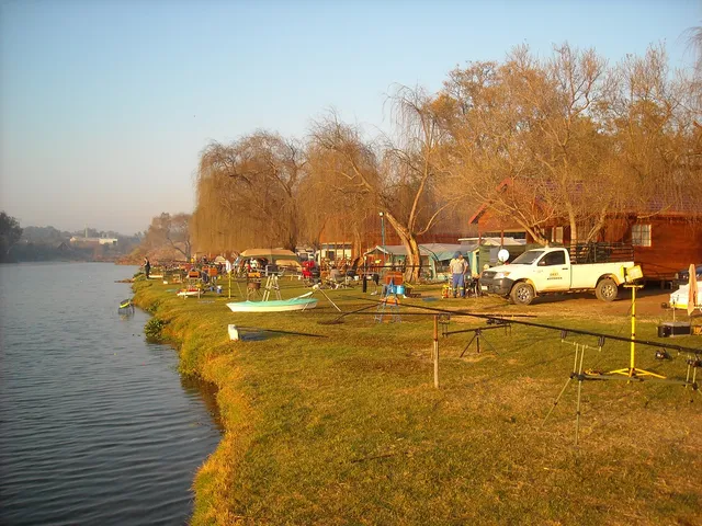 Cabins and fishing bank at sunset | Hengelaarsvriend Holiday Resort - Gauteng - Pretoria - Roodeplaat Dam