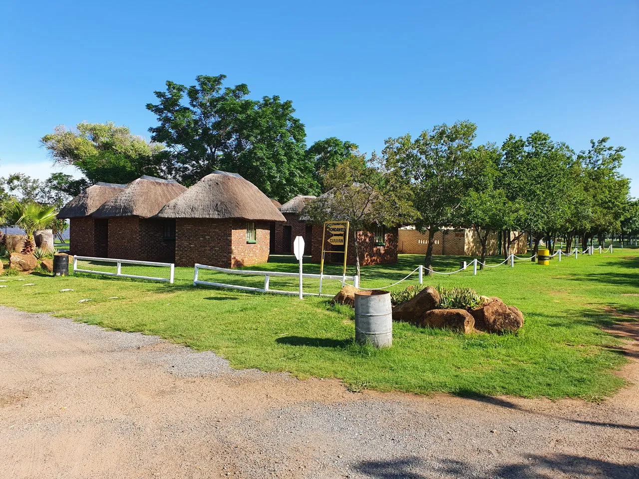 Brick rondavels under trees | Klerksdorp Dam Holiday Resort - North West - Klerksdorp - Klerksdorp Dam