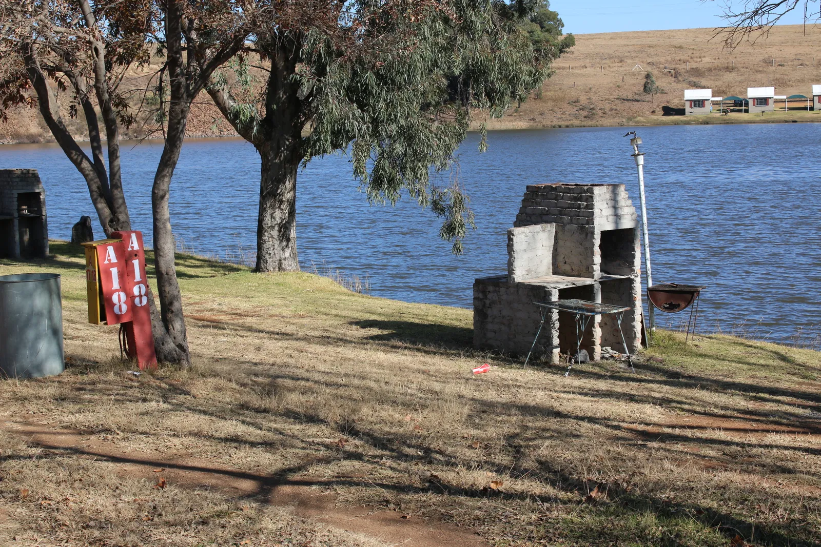 River-bank campsite with chalets across the water | Fortuna Resort - Mpumalanga - Balfour - Suikerbosrand River