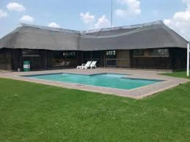 Outdoor swimming pool and thatched lapa | Jonkersdam Resort - Mpumalanga - Standerton