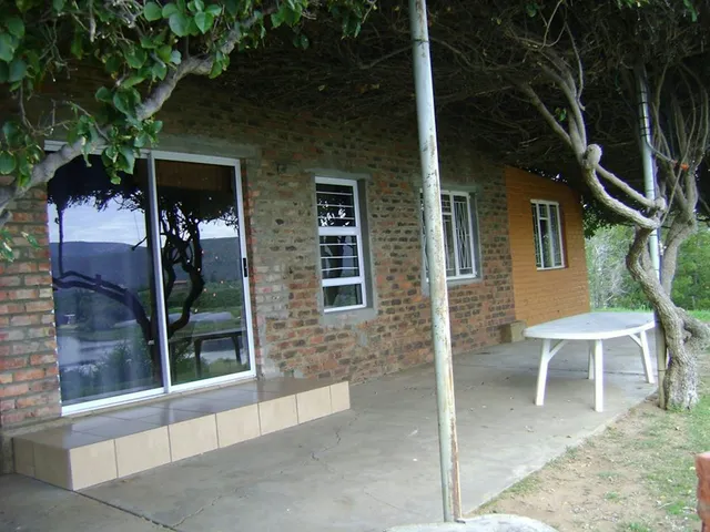 Brick cottage patio under a vine canopy at 7-Sleeper 3-bedroom Cottage 2, Rondegat Guest Farm | Rondegat Guest Farm - 7-Sleeper 3-bedroom Cottage 2 - Western Cape - Clanwilliam - Clanwilliam Dam