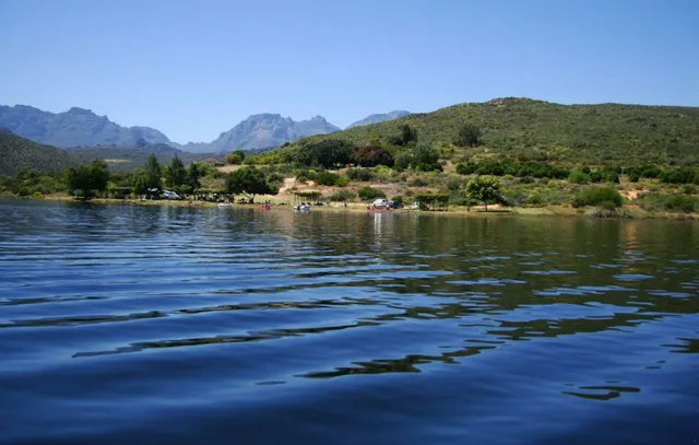 Dam water with camps along a tree-lined shore at Rondegat Guest Farm | Rondegat Guest Farm - Western Cape - Clanwilliam - Clanwilliam Dam