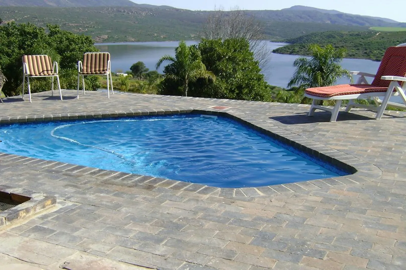 Pool deck with loungers overlooking a dam at Lakeview House, Rondegat Guest Farm | Rondegat Guest Farm - Lakeview House - Western Cape - Clanwilliam - Clanwilliam Dam