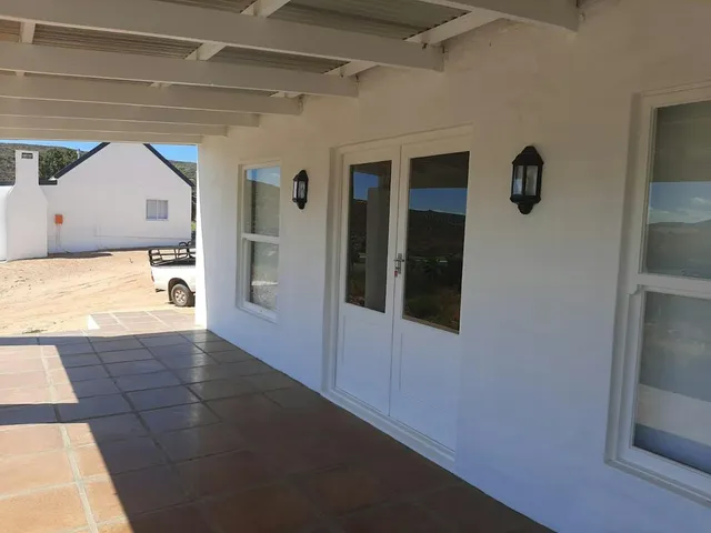Covered stoep with white doors and tiled floor at Hilltop Cottages 1 and Hilltop Cottages 2, Rondegat Guest Farm | Rondegat Guest Farm - Hilltop Cottages 1 - Western Cape - Clanwilliam - Clanwilliam Dam