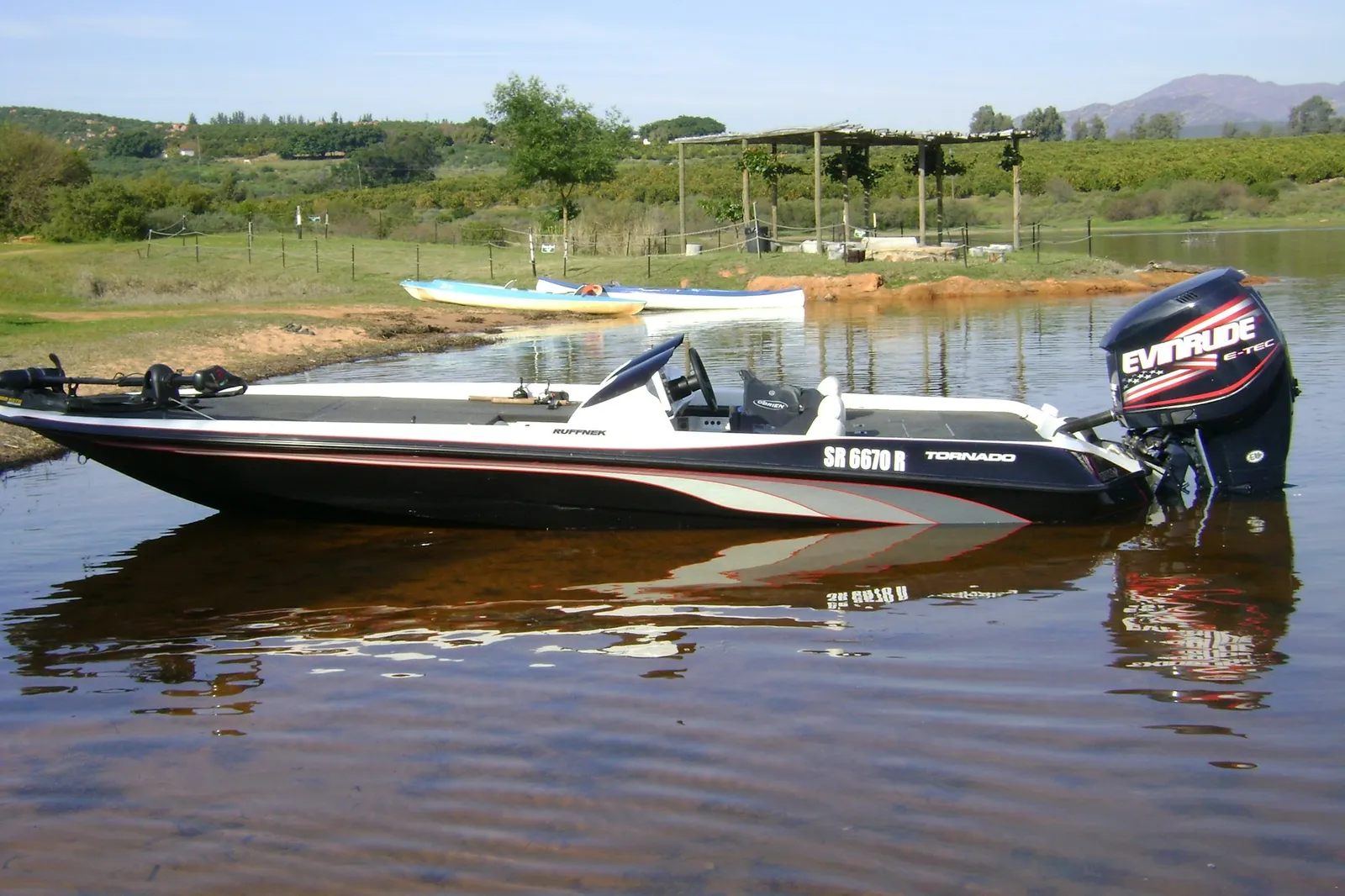 Black bass boat beached at the water edge at Rondegat Guest Farm | Rondegat Guest Farm - Western Cape - Clanwilliam - Clanwilliam Dam